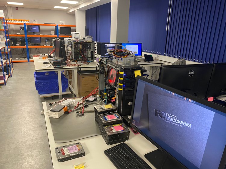 Wide view of R3 imaging lab with open systems and stacked hard drives