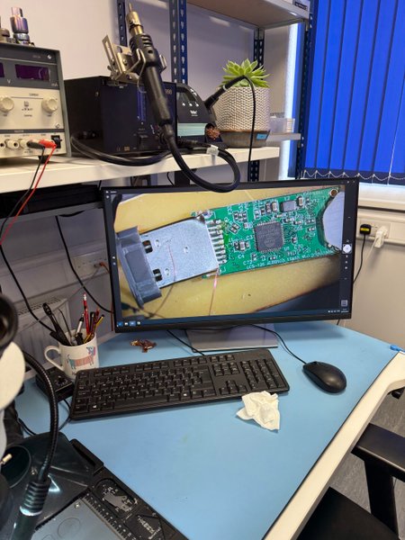 USB flash drive PCB under a digital microscope at an R3 soldering bench
